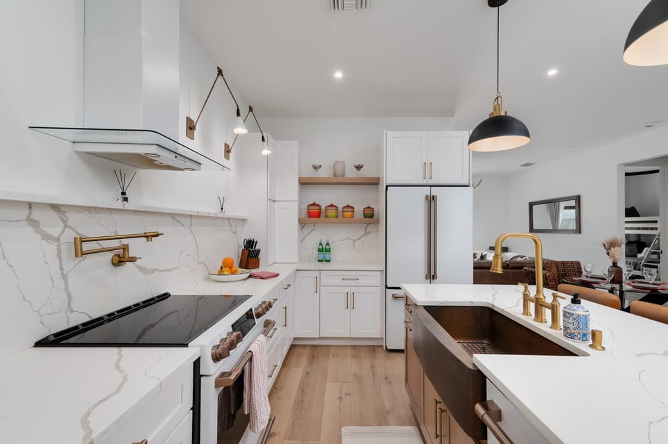 Modern kitchen with marble countertops and brass fixtures for a stylish cooking experience