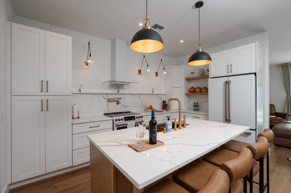 Modern kitchen with marble countertops and leather bar stools for a comfortable dining experience
