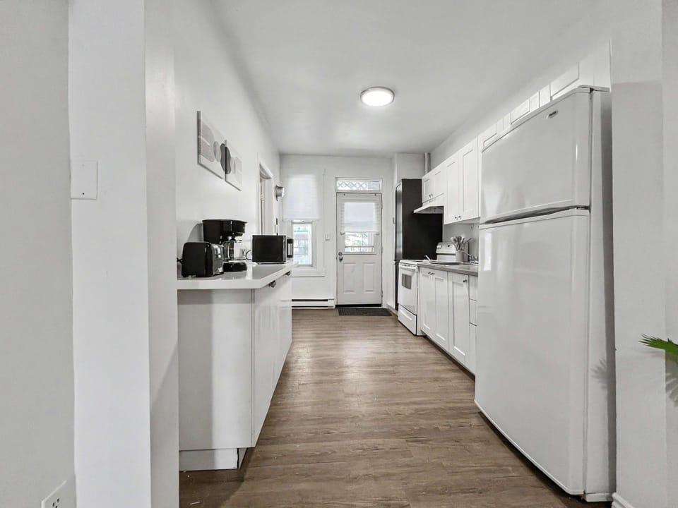 A chef’s delight! This fully equipped, sleek white kitchen has everything you need to whip up your favorite dishes.