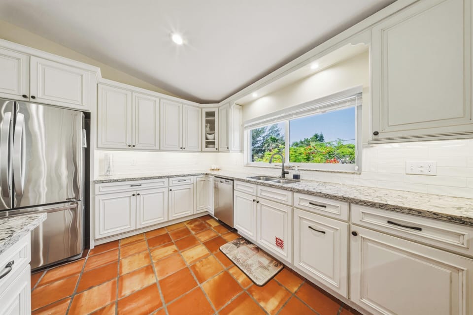 Expansive open-plan kitchen with beautiful water views in a Marathon FL waterfront vacation rental. Designed for comfort and entertaining, this home offers a private pool and prime Florida Keys location.