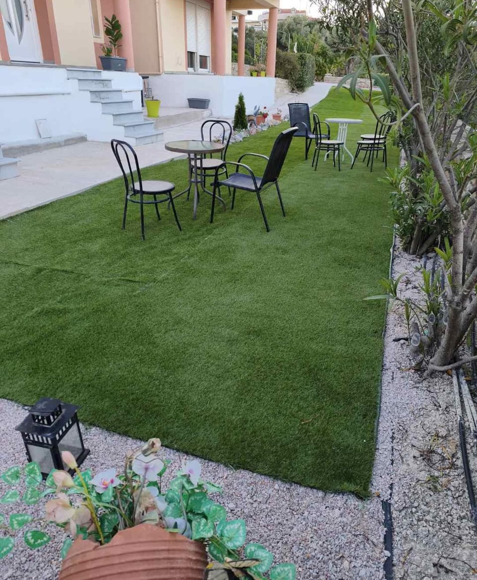 Picturesque garden pathway lined with greenery and decorative elements, offering a tranquil stroll through the property.