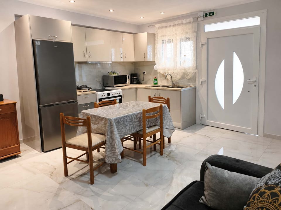 Bright open-plan kitchen and dining area with modern appliances and natural light.