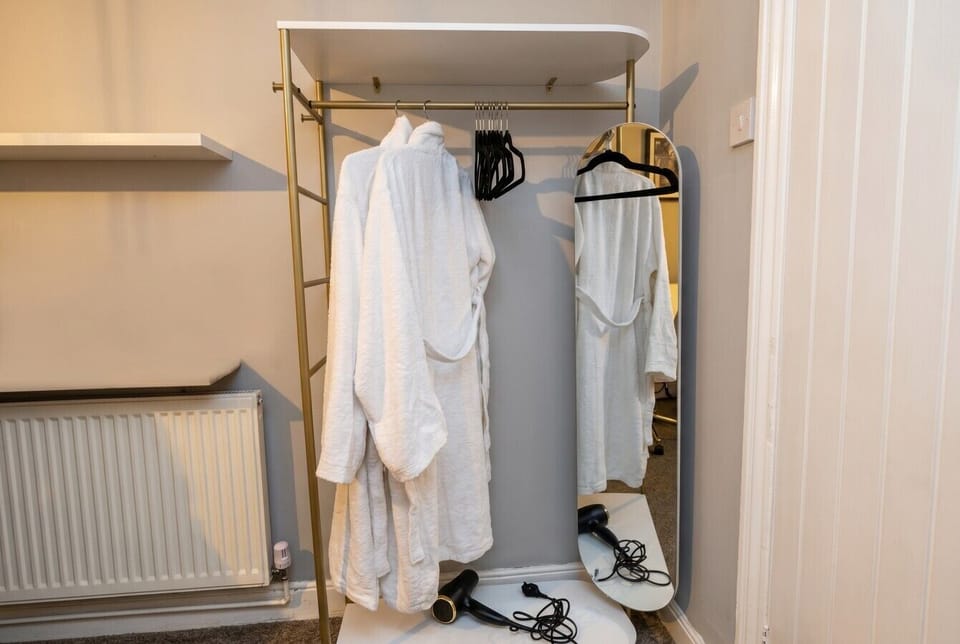 Fluffy robes and a full-length mirror make mornings feel like a hotel stay.
