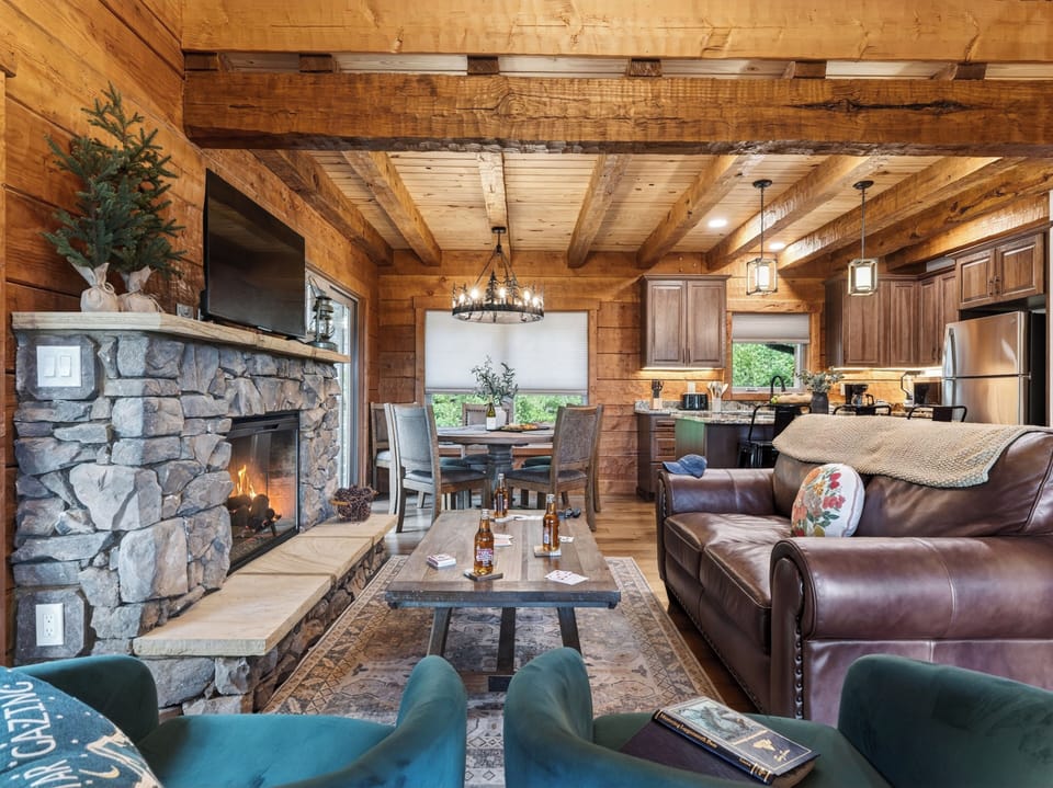 The stone-wrapped fireplace serves as the centerpiece for the living and dining areas.
