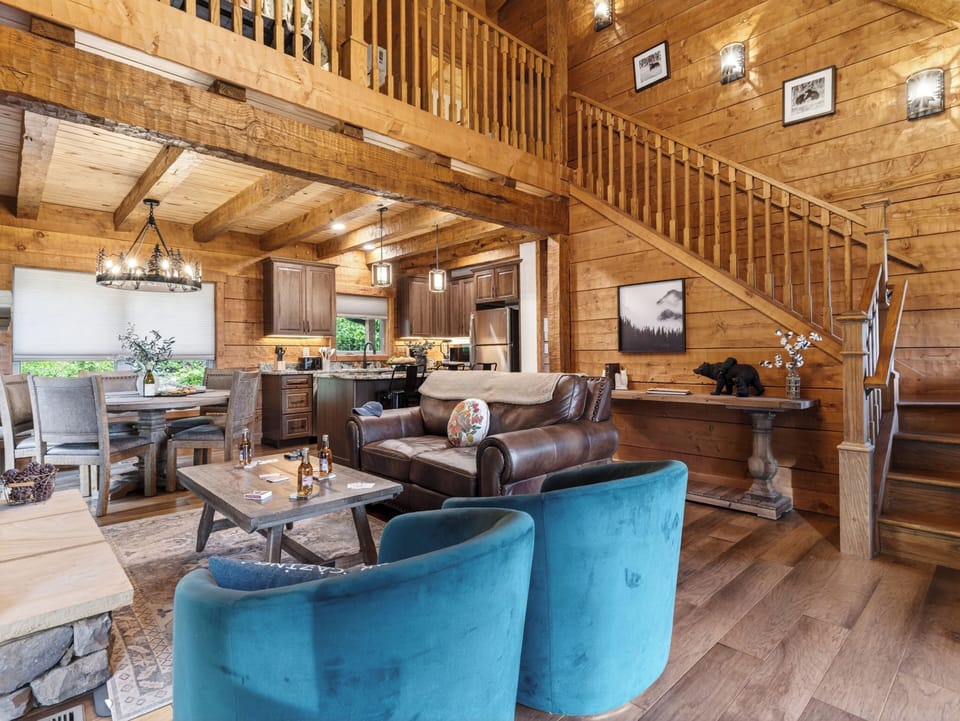 Open-concept design featuring soaring ceilings and warm wood finishes.