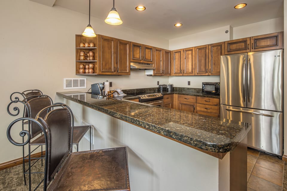 Kitchen with stainless appliances and bar seating I Main Level