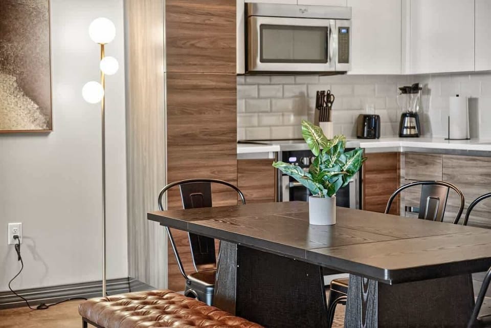 Industrial elegance: Open kitchen design with modern appliances and warm wood tones.