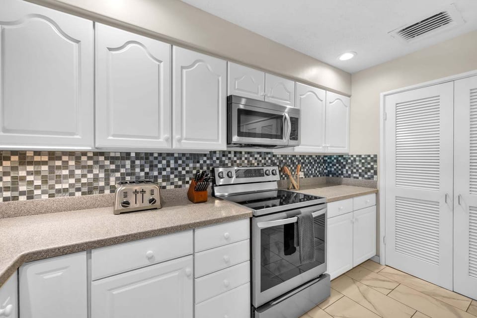 Fully equipped kitchen featuring a gas stove, stainless steel appliances, and plenty of counter space for easy meal prep