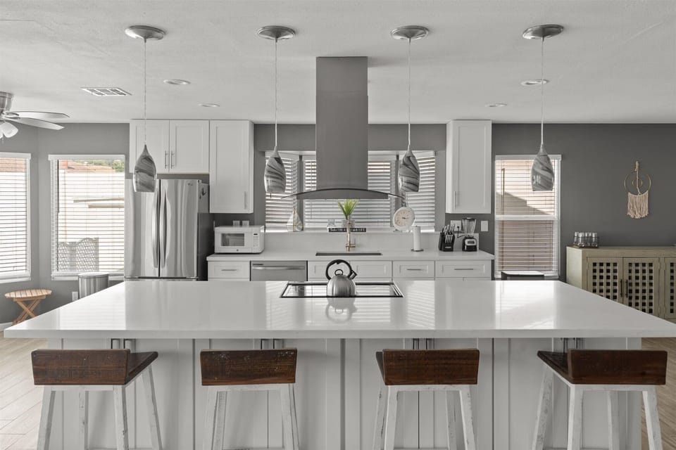 Chefs kitchen features large island and additional seating for 4