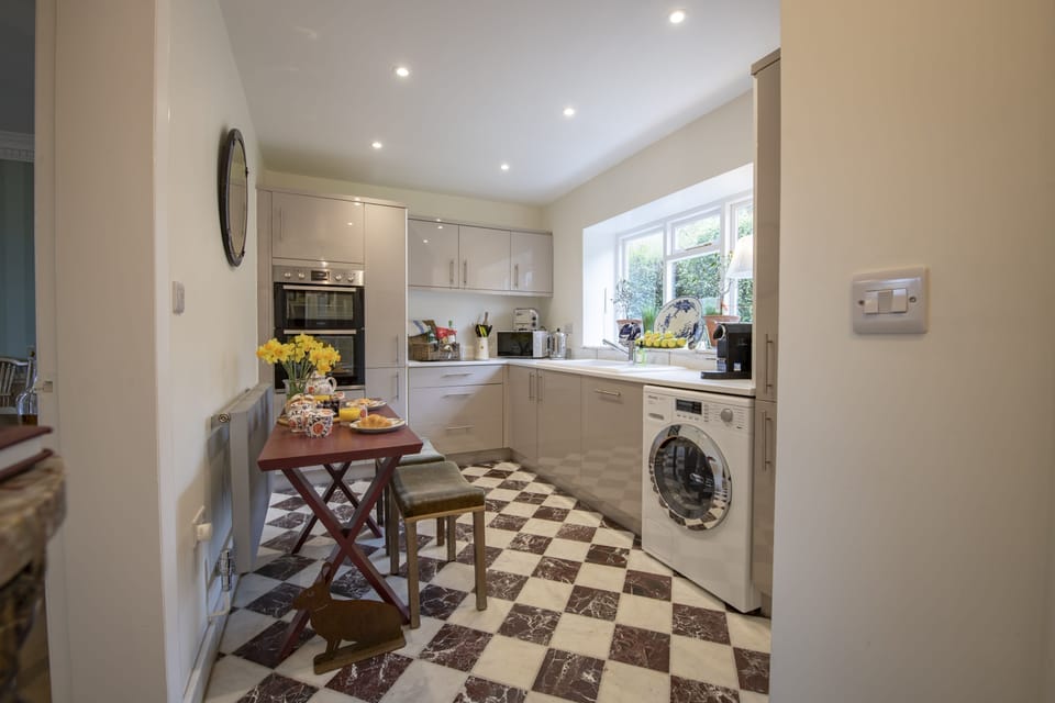 Ground floor: Delightful kitchen featuring marble stone flooring,  high quality appliances  and  breakfast seating for two