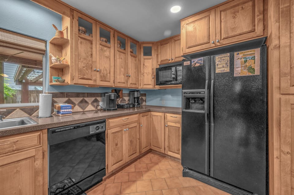 Your fully equipped kitchen features warm wood cabinetry, modern appliances, and ample counter space—perfect for preparing homemade meals during your stay.