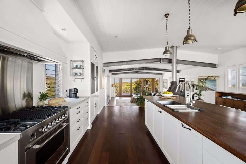 The modern kitchen allows you to prepare meals with ease, featuring a generous breakfast bar and quality appliances.