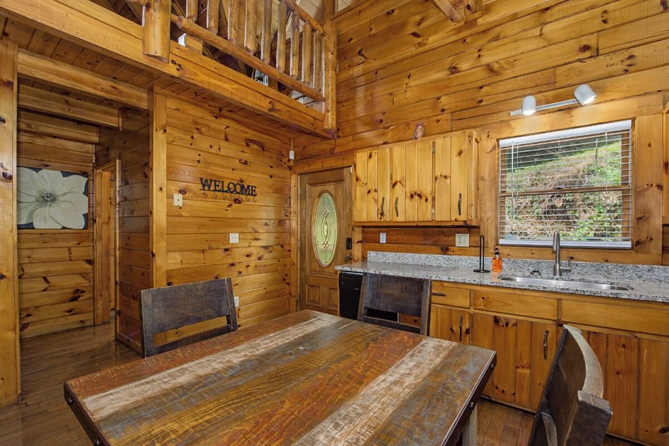 Step into the warm cabin where walls embrace you and soaring ceilings create an airy mountain retreat.