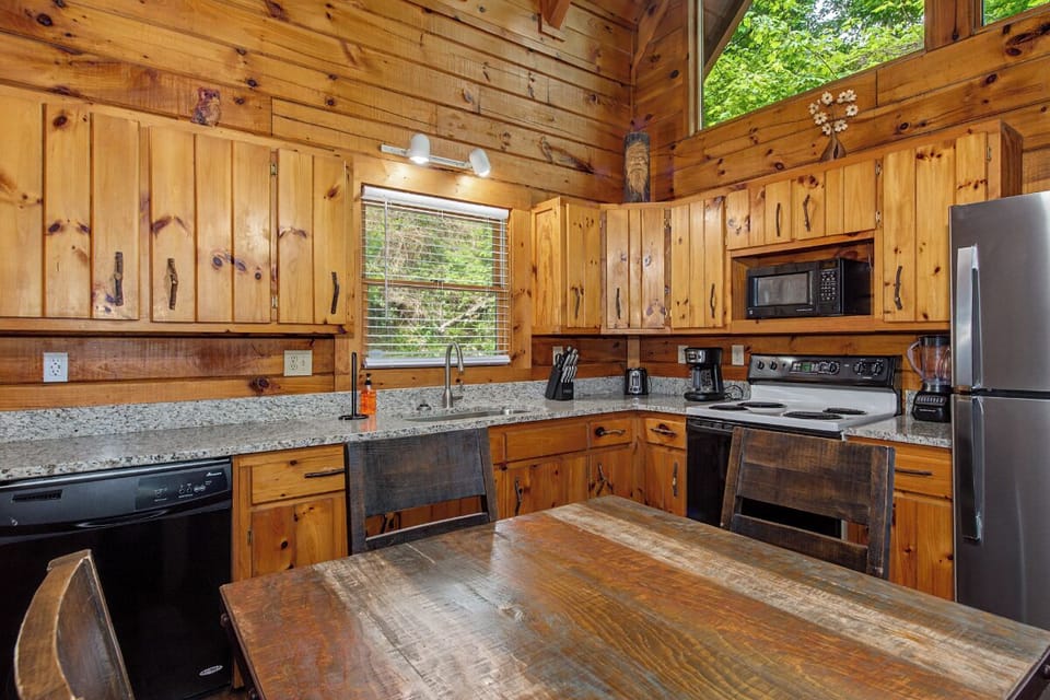 Your fully-equipped kitchen blends rustic touches with modern convenience all under soaring cathedral ceilings that bring the treetops inside.
