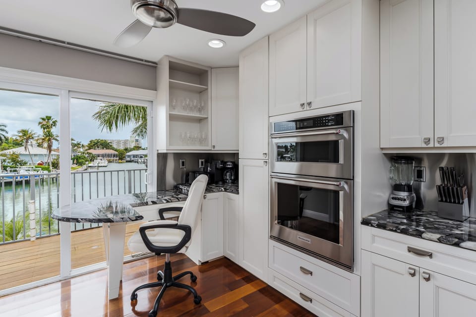 Your fully equipped kitchen features modern appliances and opens to a stunning waterfront view—perfect for preparing meals while soaking in the tropical scenery.