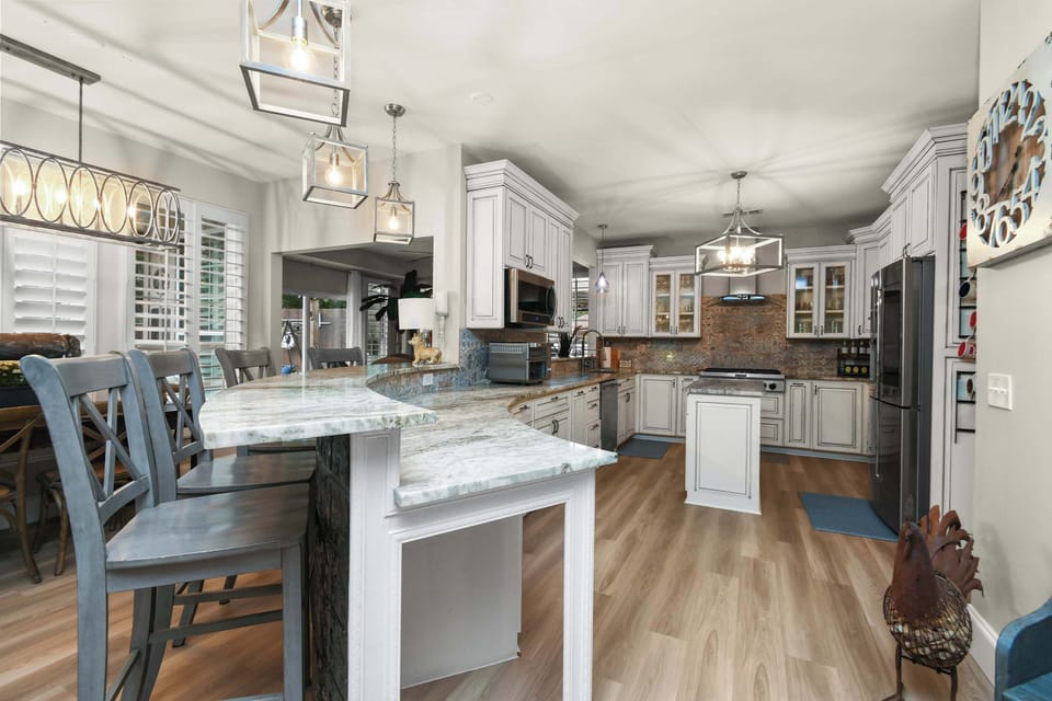 Cook, gather, and entertain in this chef-inspired kitchen with oversized island seating and elegant finishes.