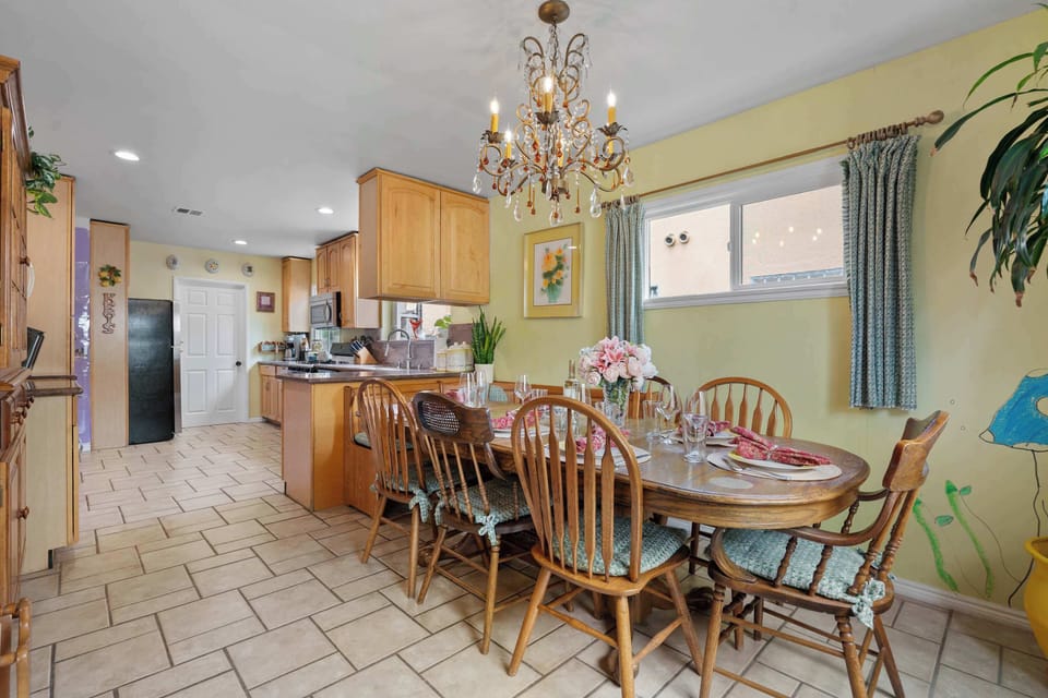 Dining Room with 6-Person Table, Chandelier, and Open Kitchen