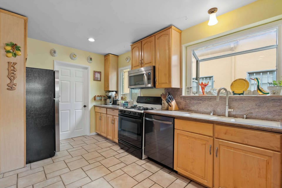 Full Kitchen with Gas Range, Stainless Appliances, and Maple Cabinets
