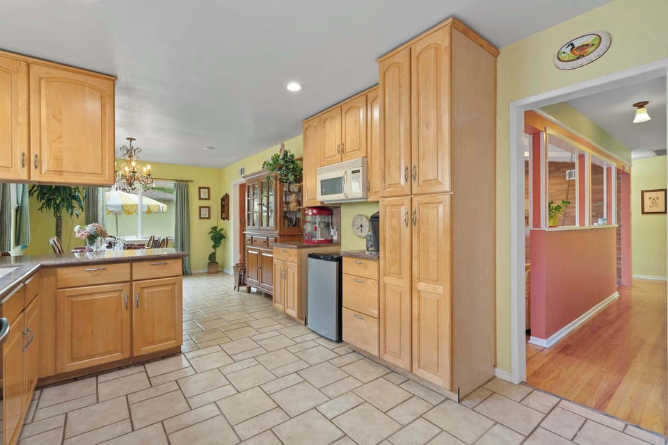 Spacious Kitchen with Ample Maple Cabinets, Open to Dining Room