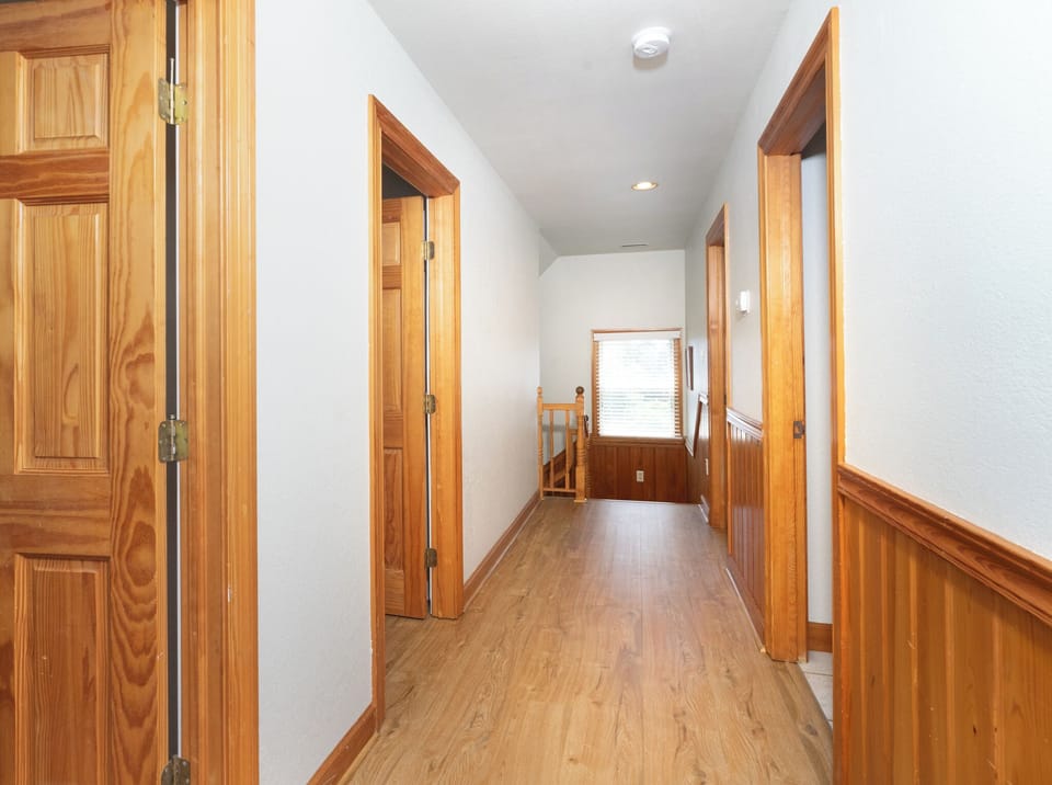 This bright hallway connects your private spaces with warm wood accents and natural light streaming through. Everything feels thoughtfully laid out for your comfort.
