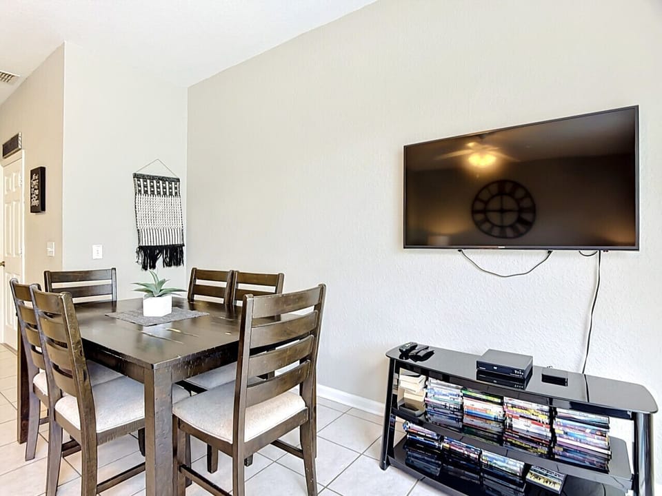 Dining space with wall-mounted TV for added entertainment.
