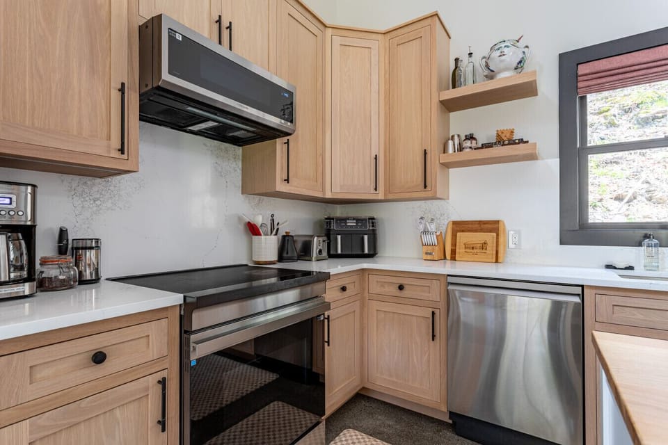 Modern, fully equipped kitchen with new stainless steel appliances