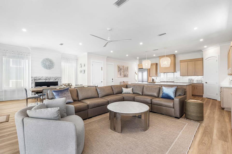 Unwind in this bright, open living space designed with your comfort in mind. Sink into plush seating, enjoy the breeze from the ceiling fan, and let the natural light set the perfect mood for your stay.