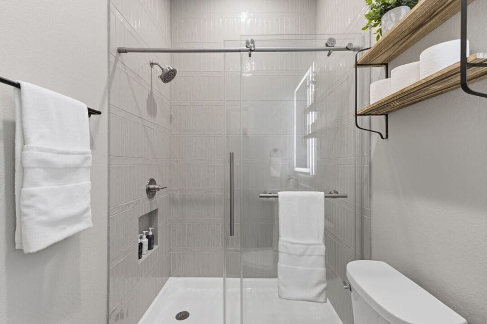 The bathroom in Bedroom 1 features a walk-in shower, making it easy to step in and unwind.