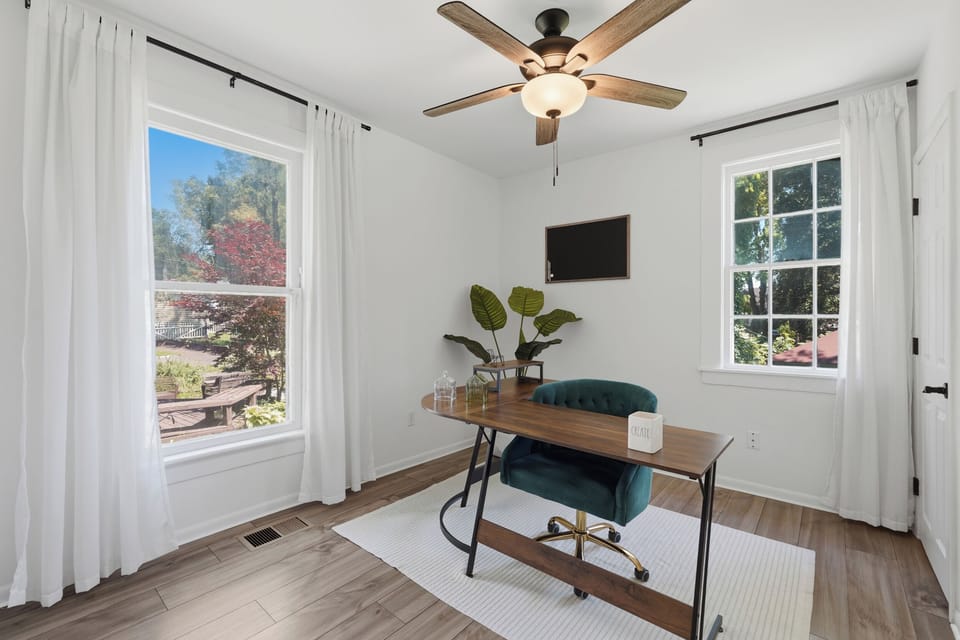 Bright home office nook with large windows and stylish modern desk