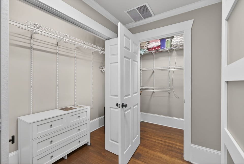 Spacious walk-in closet w/ shelving, hanging space & drawers for longer stays