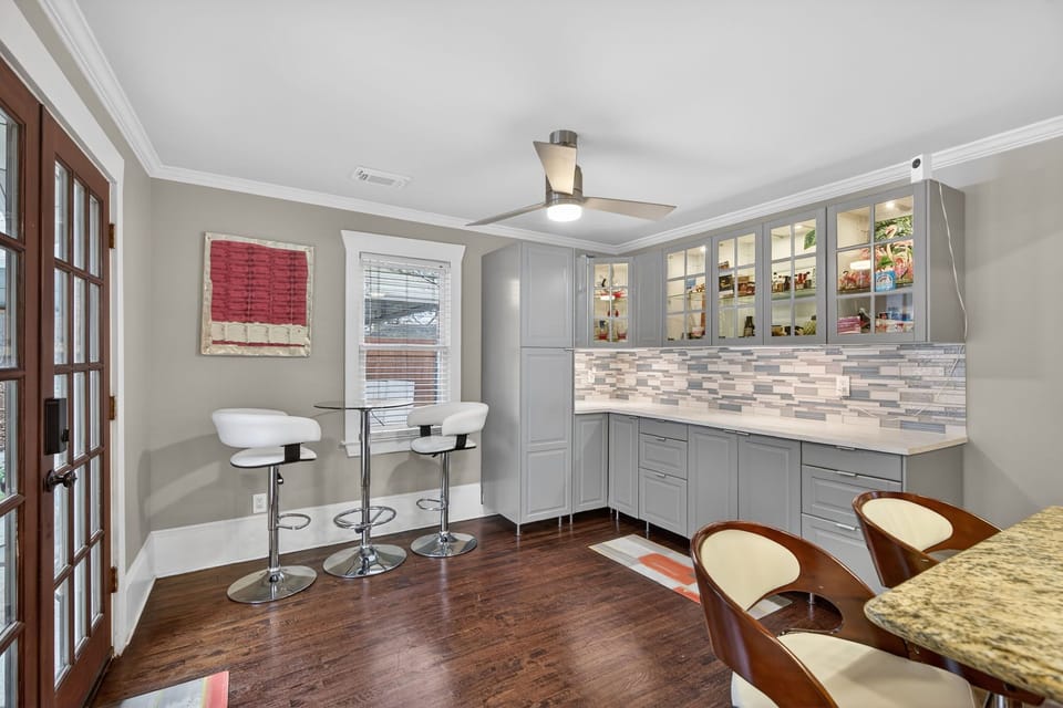 Stylish breakfast nook w/ natural light & cozy seating for morning coffee