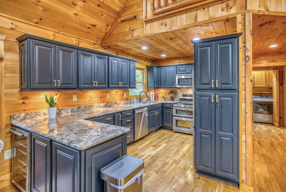 Prepare your favorite vacation meals in this impressive, fully equipped kitchen. You can make use of the sleek navy cabinetry, high-end stainless steel appliances, and expansive granite countertops that provide plenty of space for family dining.