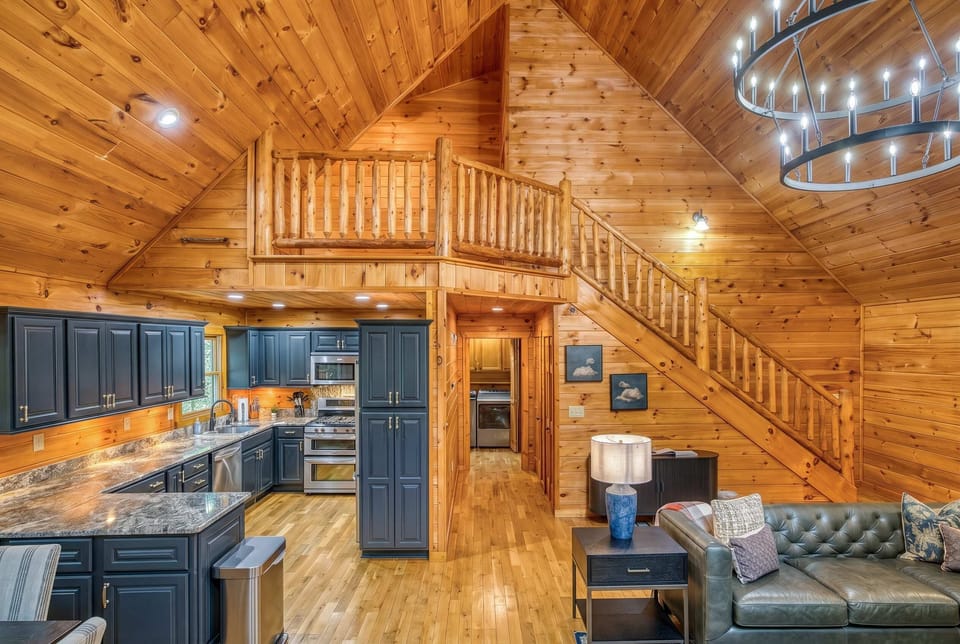 Experience the heart of this stunning A-frame cabin! You can take advantage of the open-concept living area and fully equipped modern kitchen, perfect for preparing family meals while staying connected to the conversation in the cozy lounge.