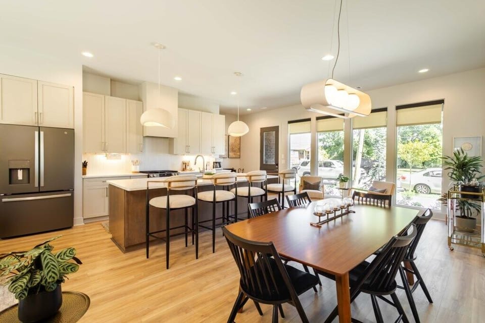 Bright open layout connecting kitchen, dining, and living spaces