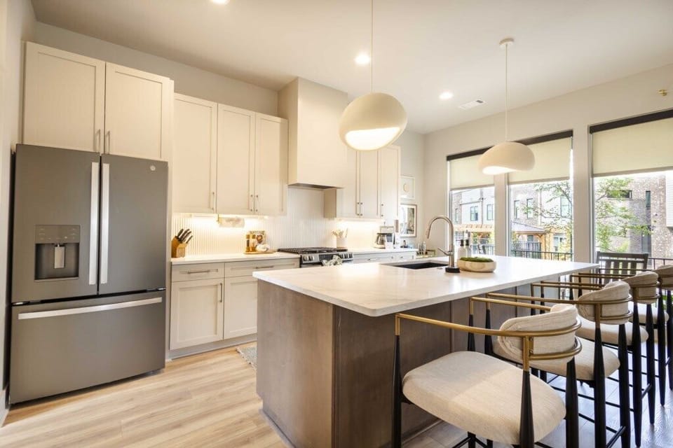 Bright modern kitchen featuring a large island, sleek finishes, and plenty of space to cook, dine, and unwind