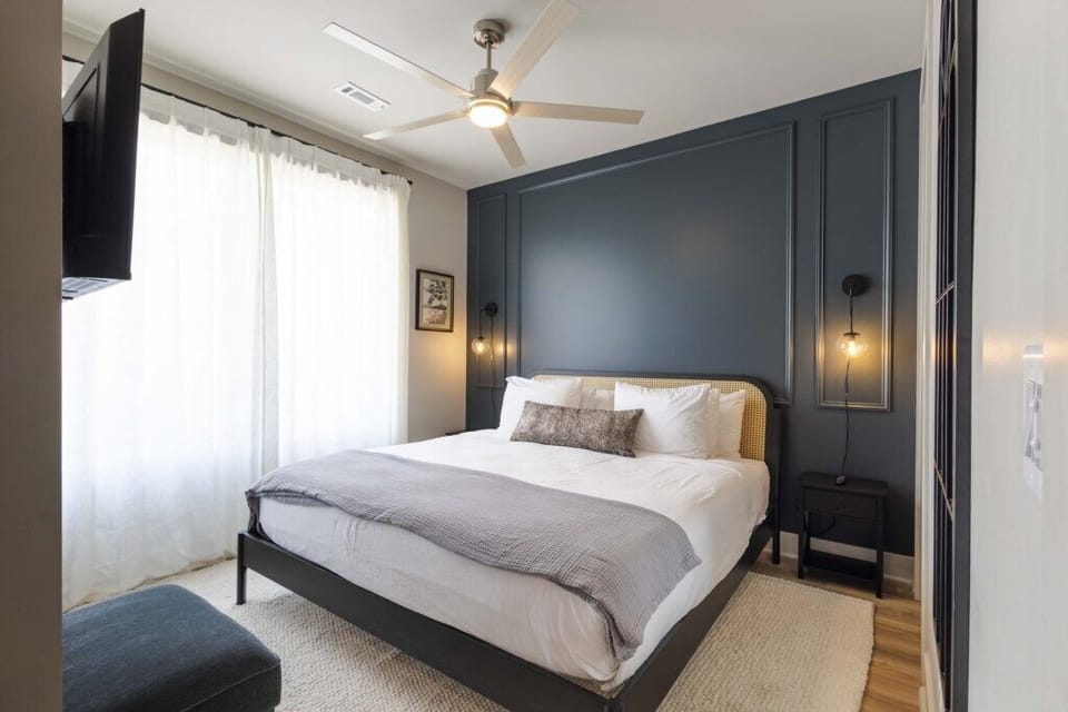 Bedroom 4- Relaxing bedroom with king sized bed, blackout shades, Smart TV, and a plush pillow top mattress cover. 