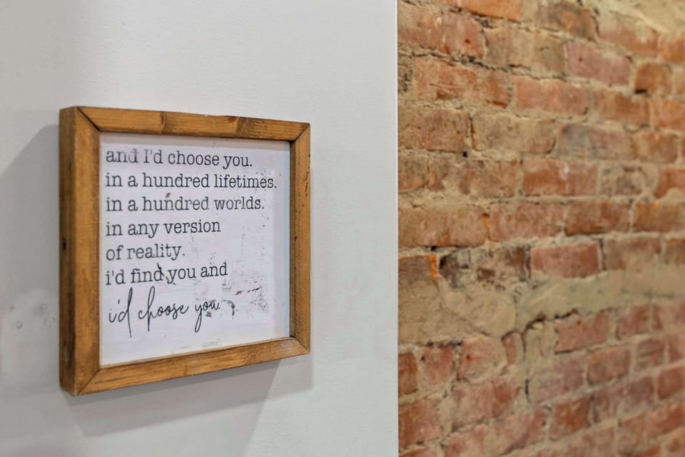 Smile at the charming framed quote adding character to the brick wall.