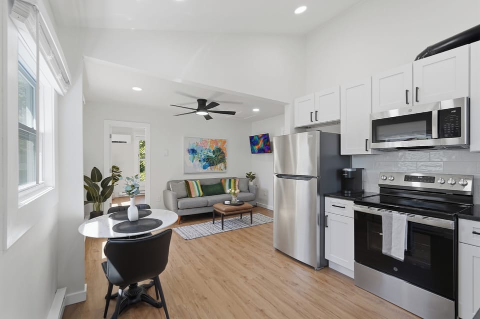 Bright modern kitchen with stainless appliances and cozy breakfast nook
