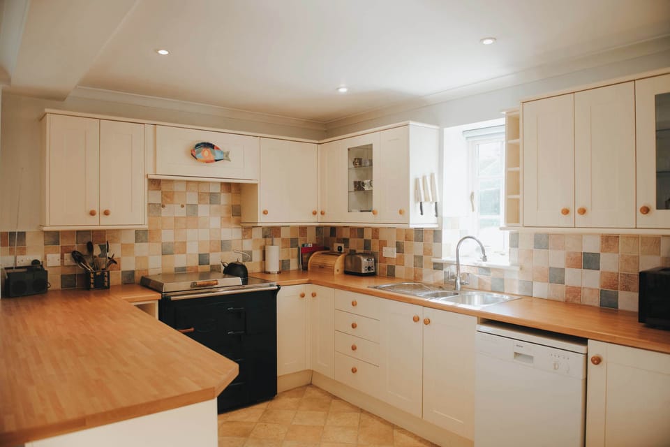 Prepare relaxed dinners and easy breakfasts in the bright country kitchen, designed for gathering together after days exploring nearby Richmond.