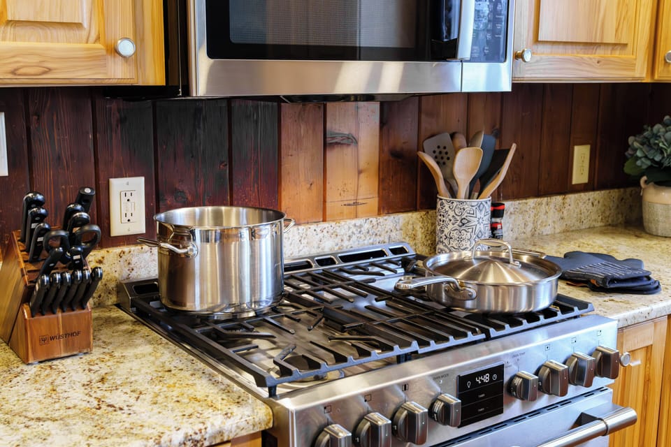 Thoughtfully stocked for home-cooked meals, this kitchen features modern appliances and classic lakehouse charm.