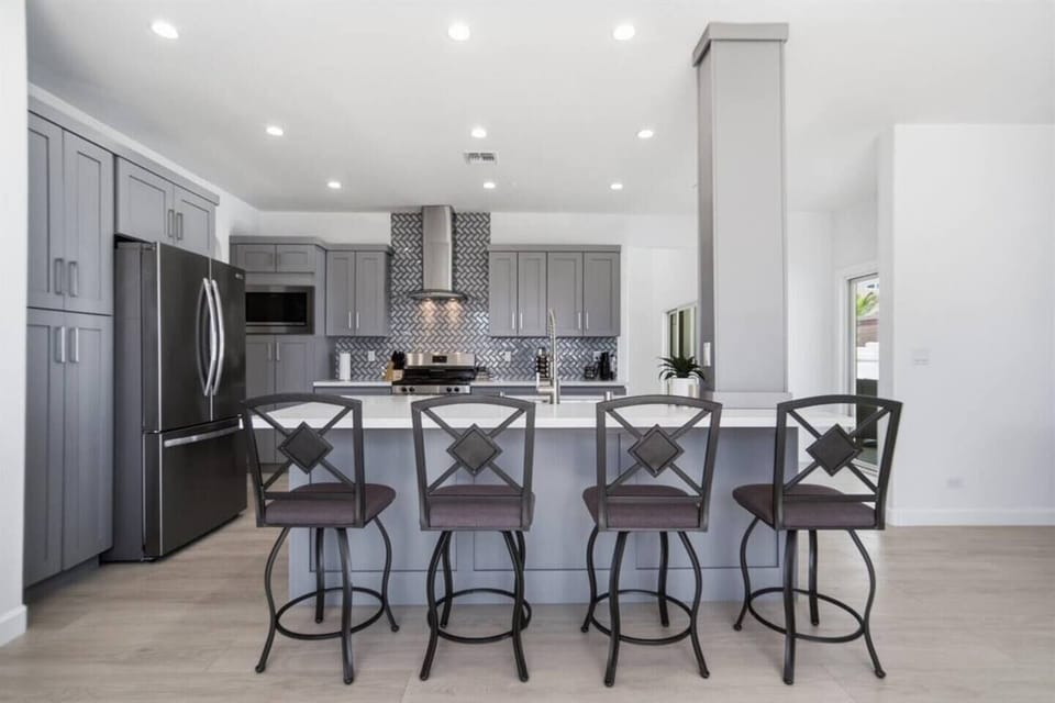 Fully stocked kitchen with bar seating and modern appliances.