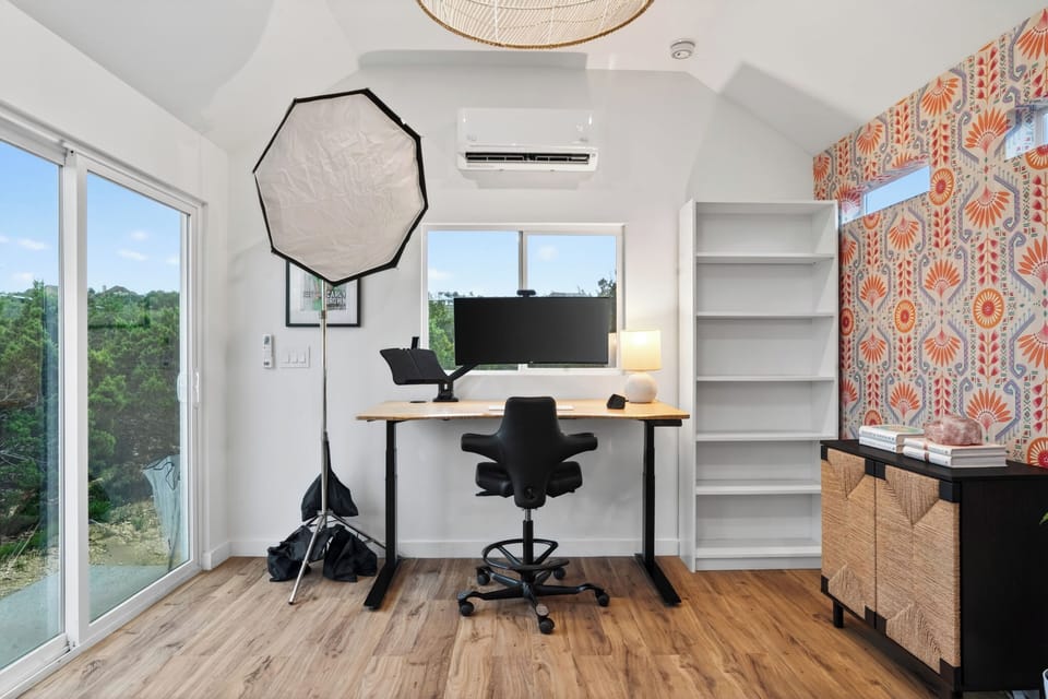 A bright creative workspace with scenic views, stylish décor, and a dedicated setup perfect for remote work, content creation, or focused productivity.