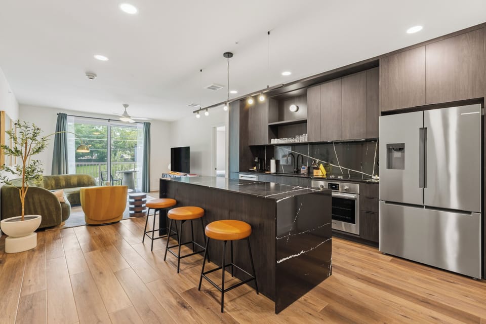 Stunning kitchen with an island and stainless steel appliances. (Unit 209)
