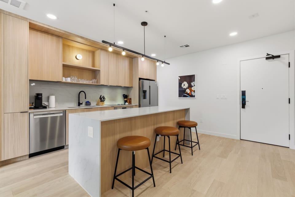 Stunning kitchen with an island and stainless steel appliances. (Unit 210)