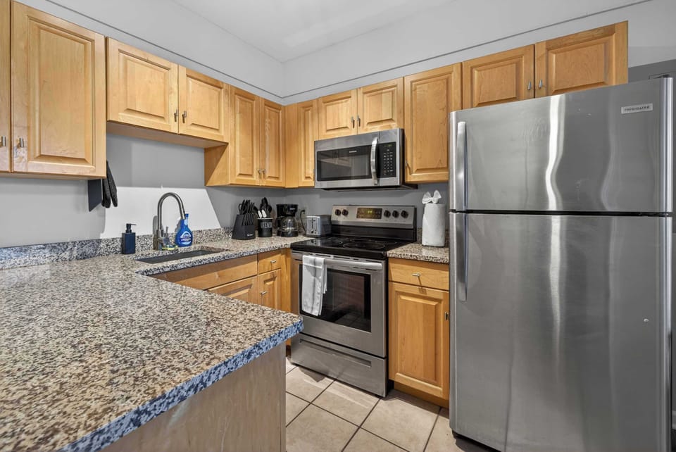 Bright kitchen w/ stainless appliances & an open setup for effortless meals together