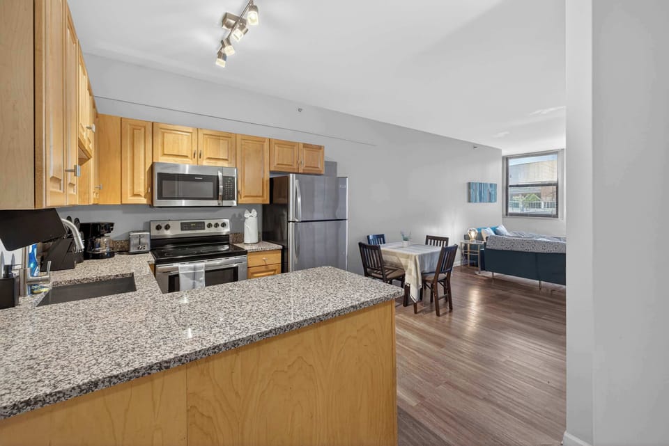 Spacious kitchen w/ wraparound counters, stainless appliances & open flow to dining