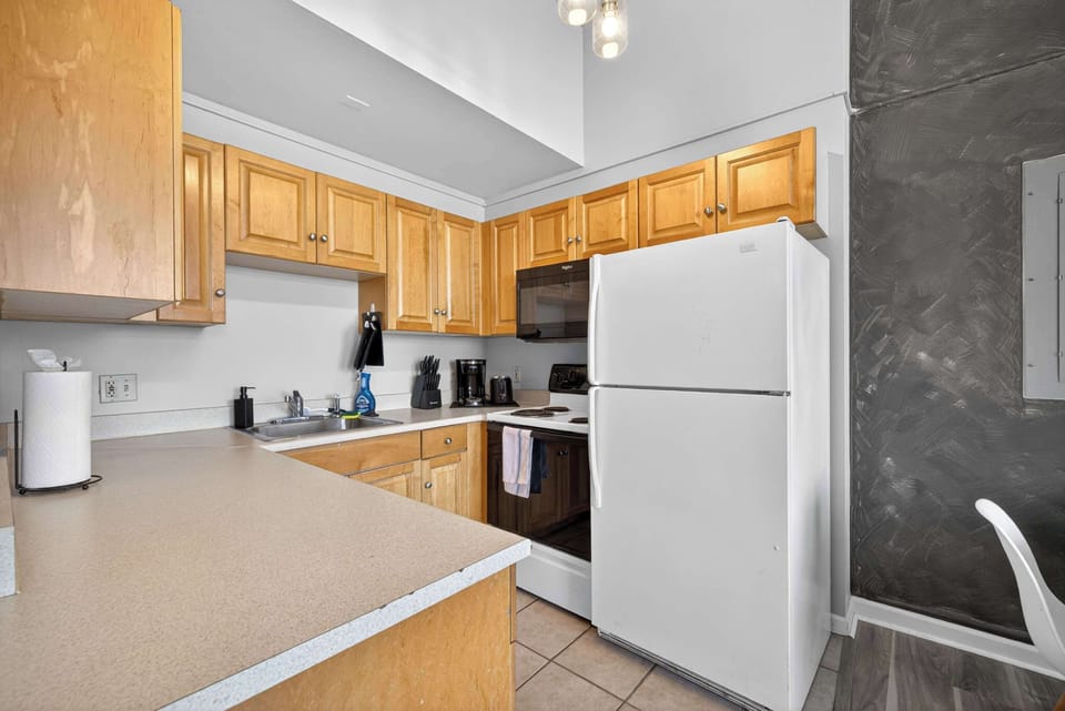Functional kitchen w/ ample counter space, wood cabinetry & everything close at hand