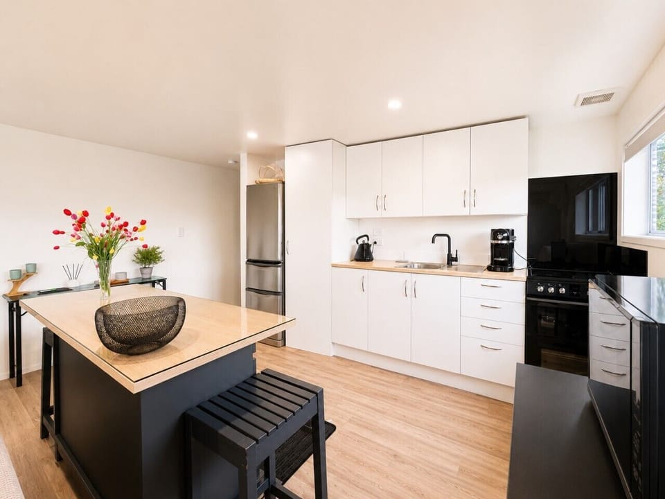 Bright minimalist kitchen with coffee machine and convenient amenities