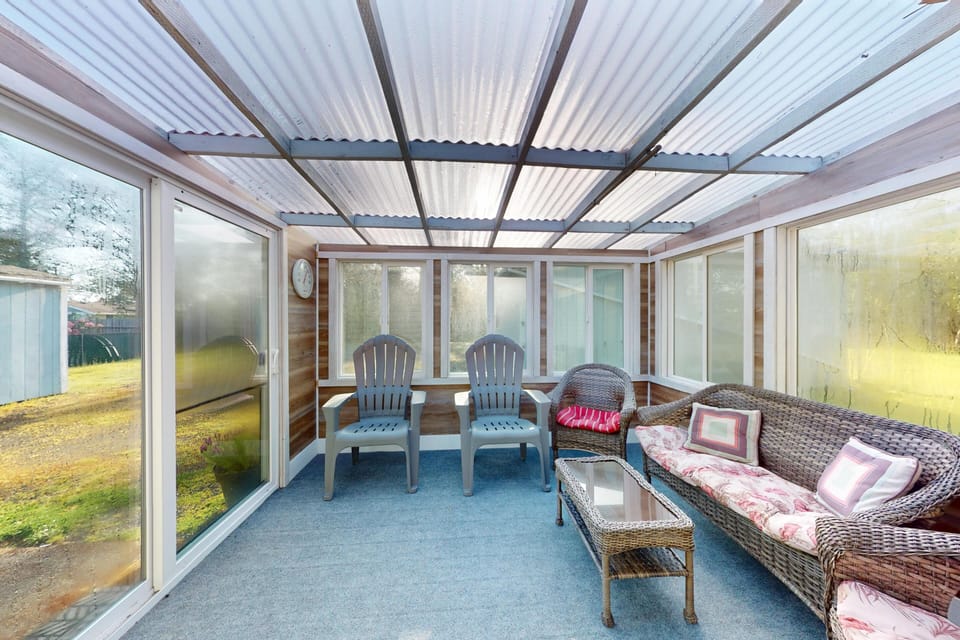 Enclosed outdoor patio with comfortable seating for relaxing year-round.
