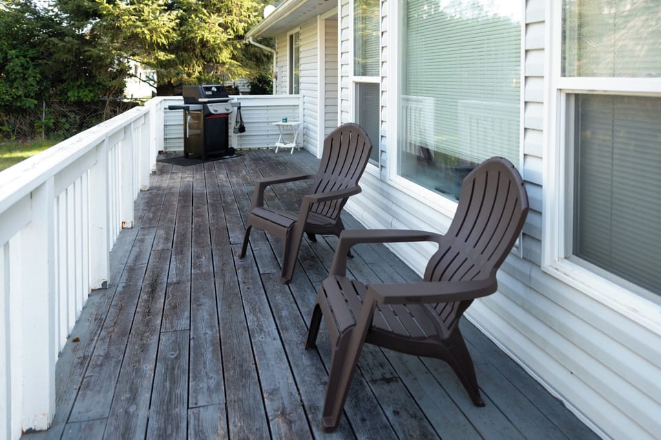 Spacious outdoor deck with seating, perfect for morning coffee or evening relaxation.